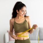 Fit young Indian woman in sports clothes